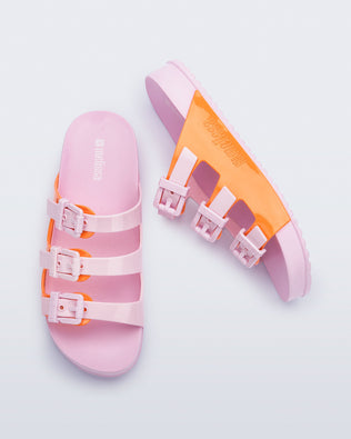 Top and side view of a pair of pink and orange Cozy Stripes slides