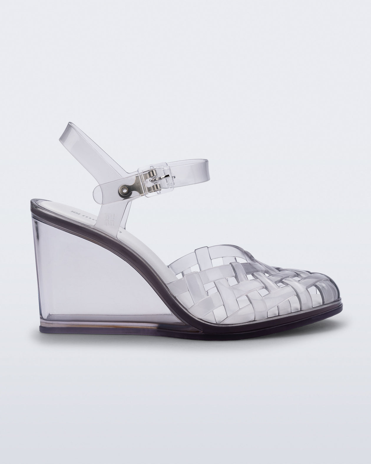 Side view of a clear grey Agata wedge heel sandal with ankle strap