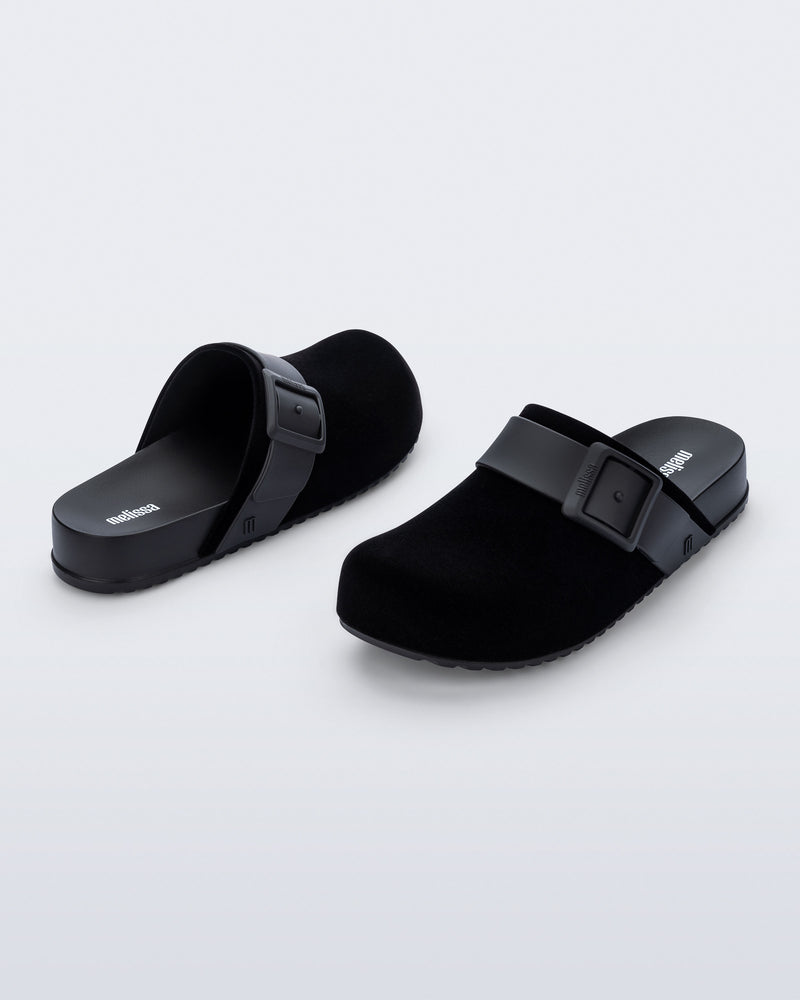 Back and front angled view of a pair of black Cozy Clog Velvet slides