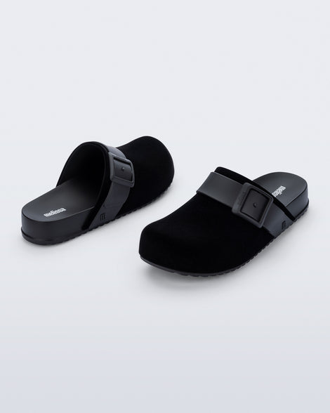 Back and front angled view of a pair of black Cozy Clog Velvet slides