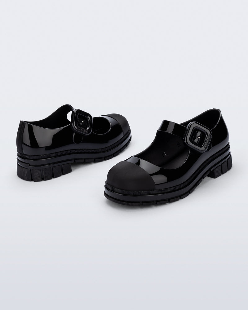 Back and side angle view of a pair of black June mary janes with matte toe cap