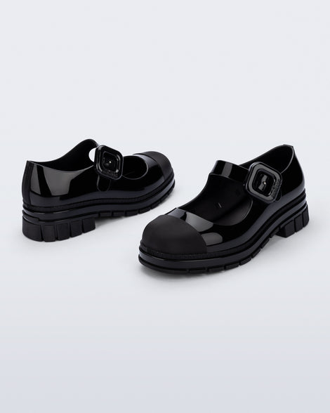 Back and side angle view of a pair of black June mary janes with matte toe cap