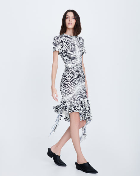 Model in a black and white wearing a pair of matte black Texas Mule heels