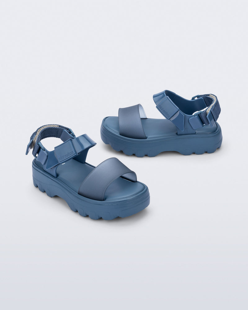 Side and front angled view of a pair of blue Kick Off kids sandals
