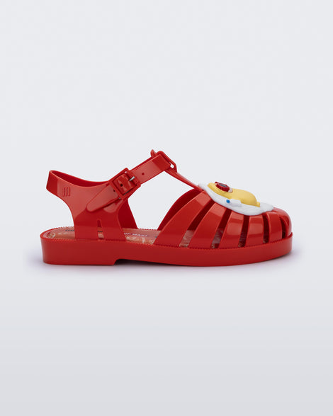 Side view of a red Possession + Pop Mart Pucky fisherman kids sandal