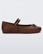 Side view of a Melissa Sophie ballet flat in bronze with M-logo strap and bow applique