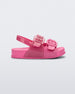 Side view of a pink glitter Mini Melissa Cozy sandal with two front straps with buckle detail