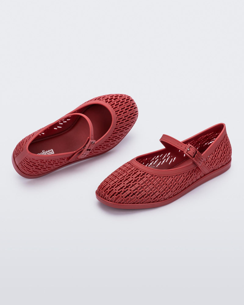 Top and angled view of a pair of red Harper ballet flats with top strap with buckle