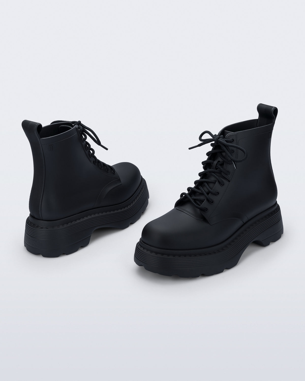 Back and front angled view of a pair of matte black Coturno Soft Platform boots