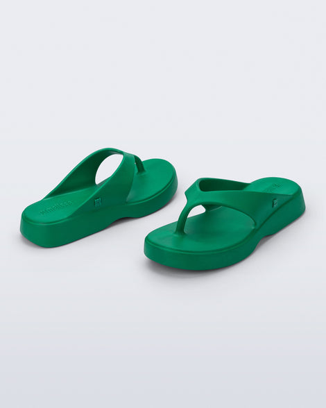 Angled view of a pair of green Free Thong Low Flip Flops