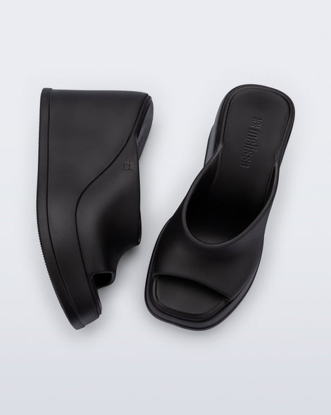 Top and side view of a pair of black Free Slip platform wedge heels