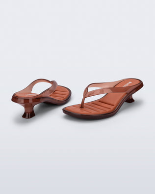Back and angled view of a pair of brown Flip Flop Kitten Heels with clear brown straps