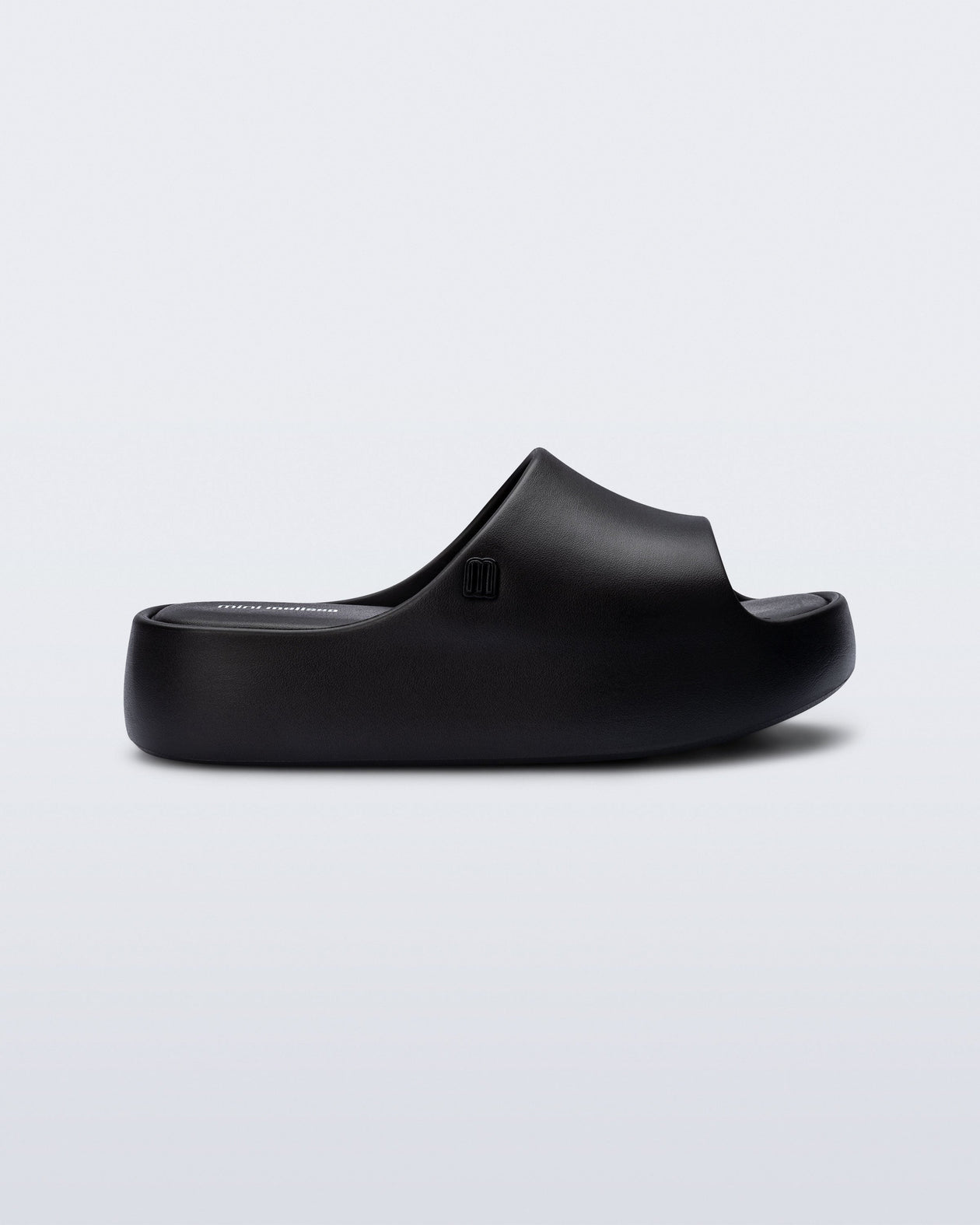 Side view of a black Free Platform Slide kids sandals