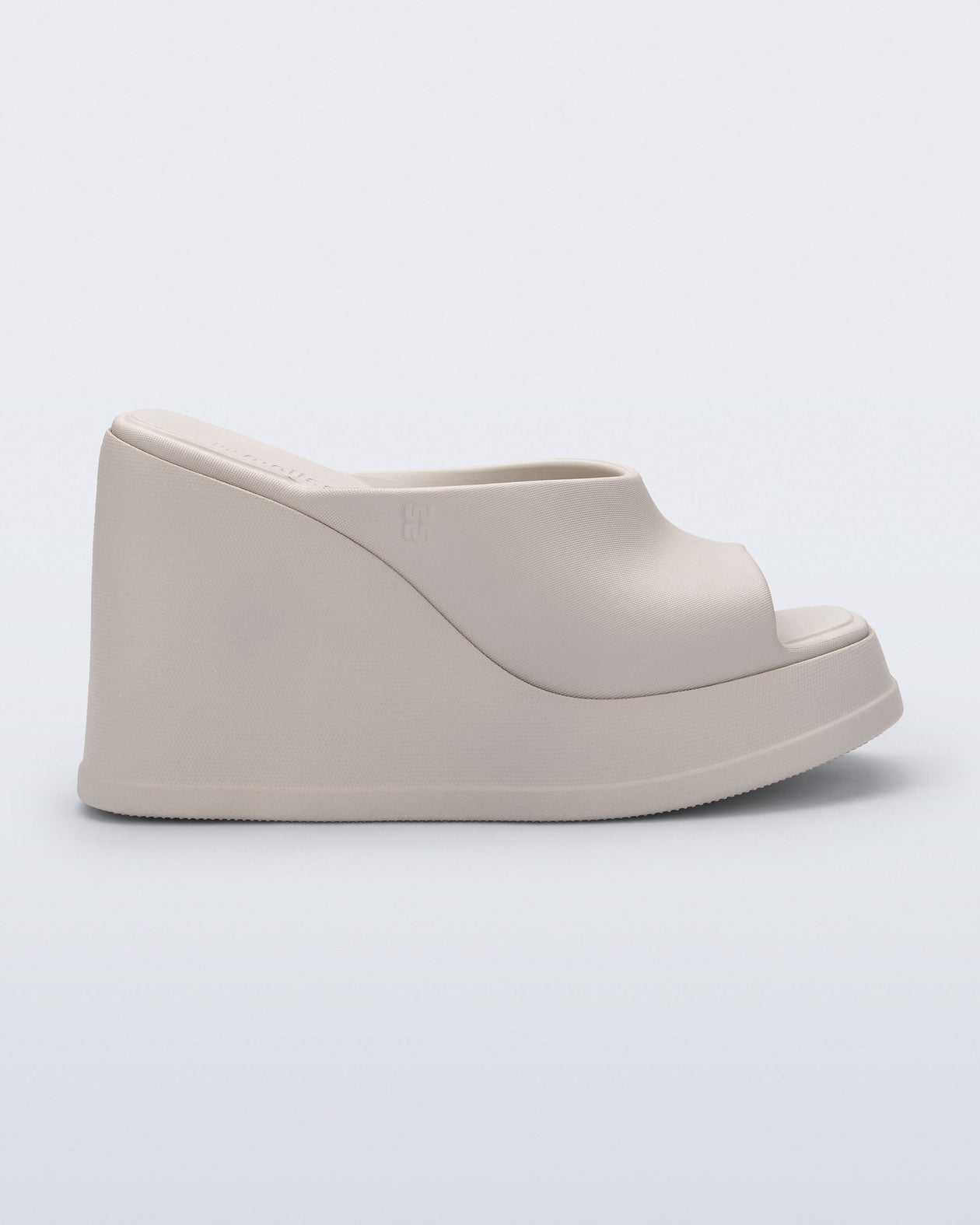 Side view of a beige Free Slip platform wedge heel