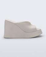 Side view of a beige Free Slip platform wedge heel