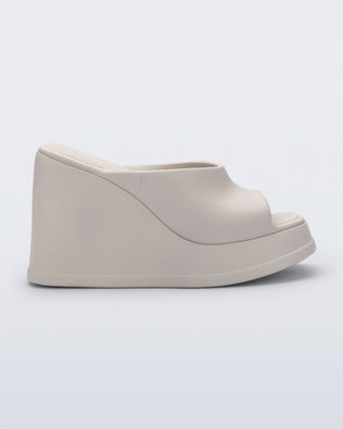 Side view of a beige Free Slip platform wedge heel