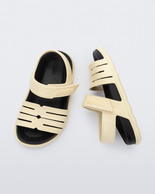 Top and side view of a pair of beige with black insole Kaiteki baby sandals