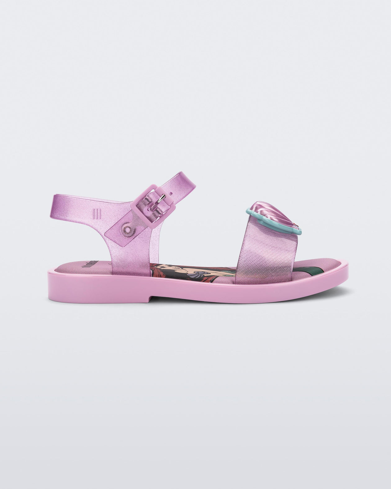 Side view of a glitter pink Mini Melissa Mar Sandal Princess sandal with a seashell detail on the front strap, an ankle strap and Princess Ariel soul