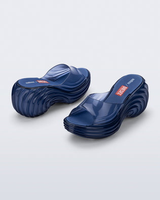 Side and back angled view of a pair of clear blue Quantum Platform sandals