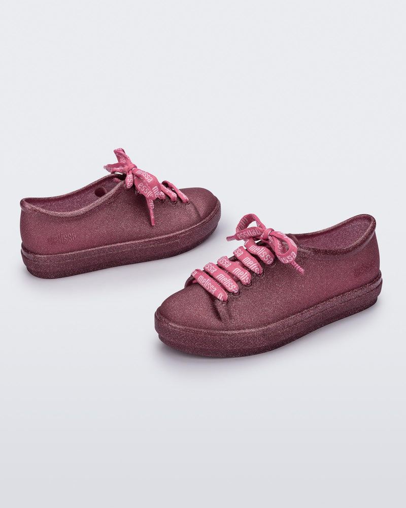 Angled view of a pair of glitter pink Hip M Lover kids sneakers with laces.