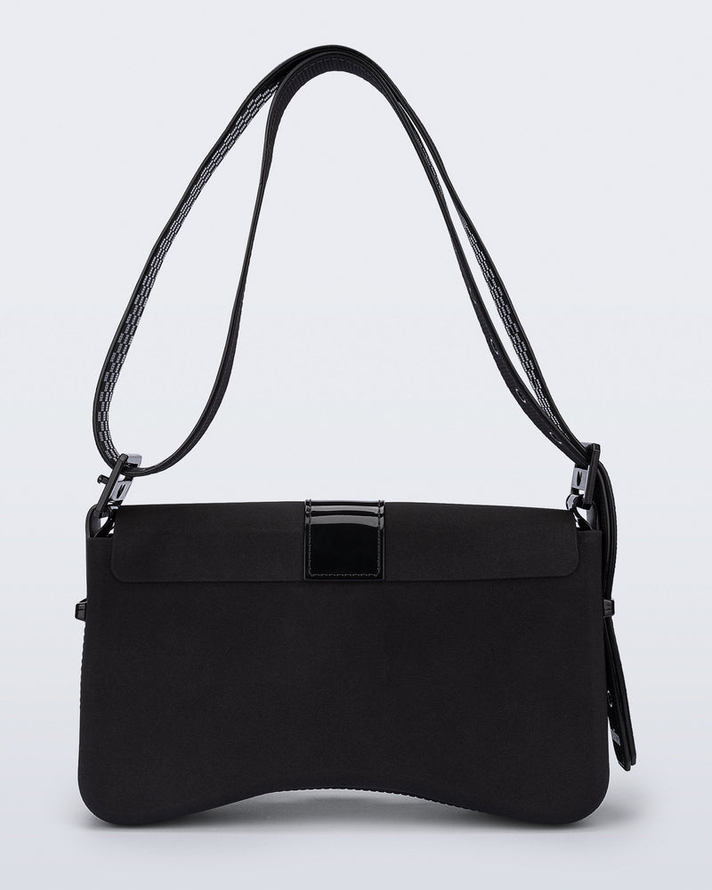 Back view of a black Cargo bag with two small pockets on the front and an adjustable strap