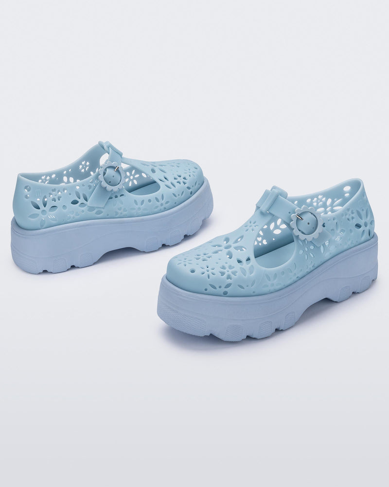 Angled view of a pair of pink Kick Off Lace women's platform shoe with buckle.