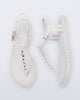 Top and Side view of a pair of white Solar Boho t-strap sandals with ,metallic detailing on the front strap