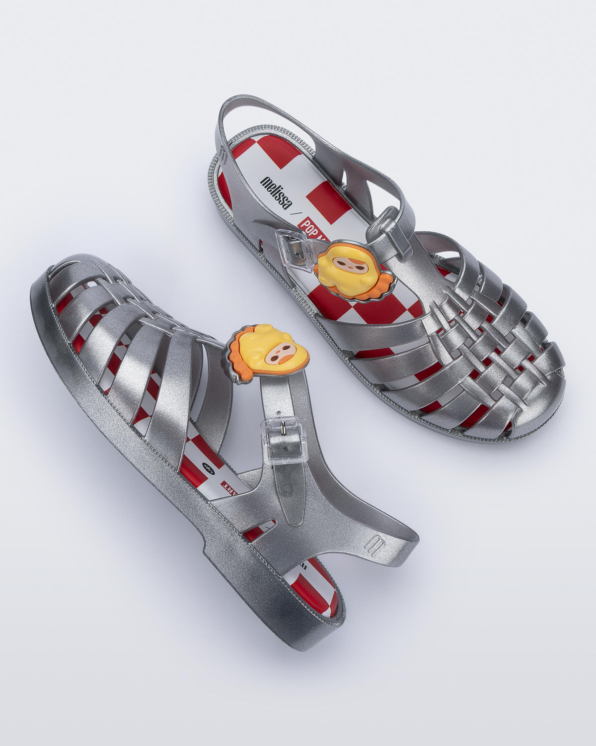 Top view of a pair of silver Possession + Pop Mart Pucky fisherman sandals
