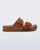 Side view of a brown Cozy slide with part clear brown upper with 2 buckles