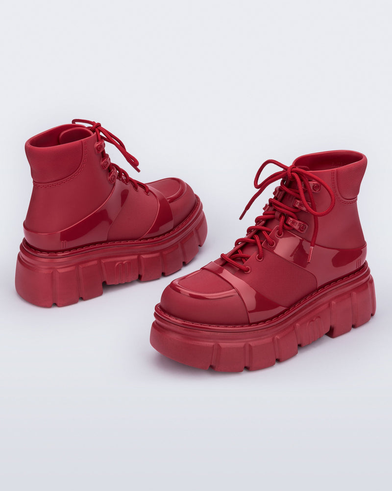 Back and side angled view of a pair of red Rebel Boots with laces