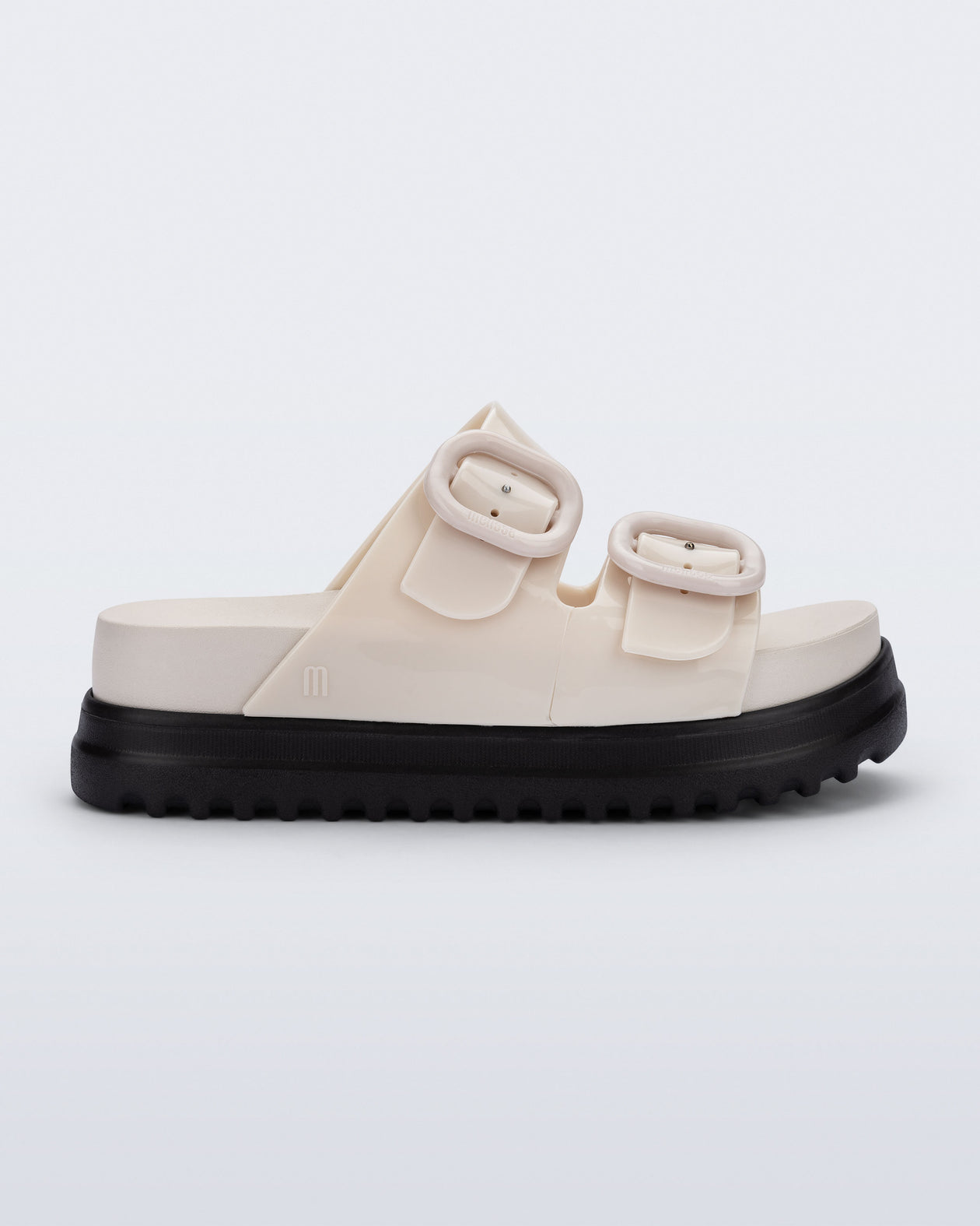 Side view of a beige Cozy Platform kids slide with two straps with buckles and black sole
