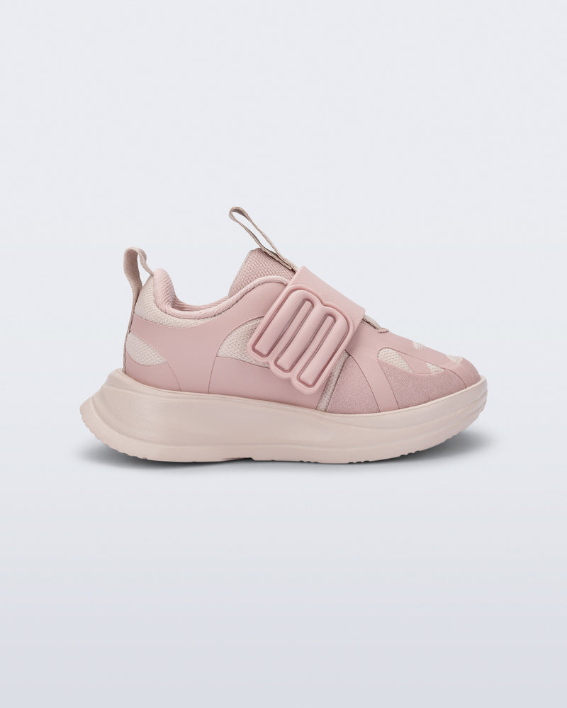Side view of a pink X Beat baby sneaker