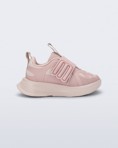 Side view of a pink X Beat baby sneaker