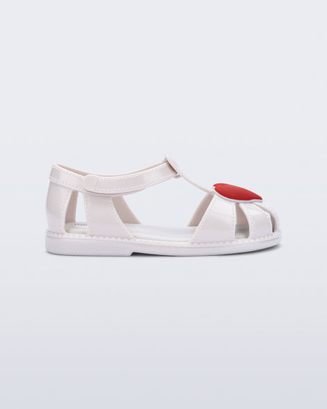 Side view of a white Hip Heart Ballerina baby sandal with red heart on front