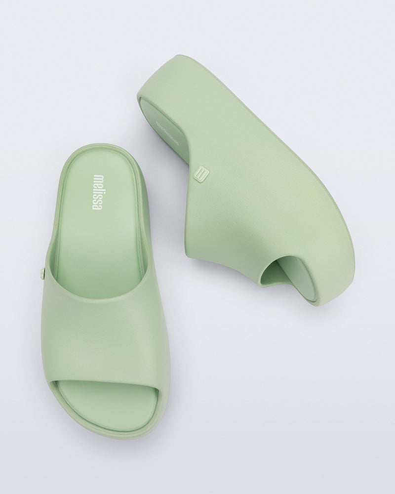 Side and top view of a pair of light green Free Platform Slide sandals