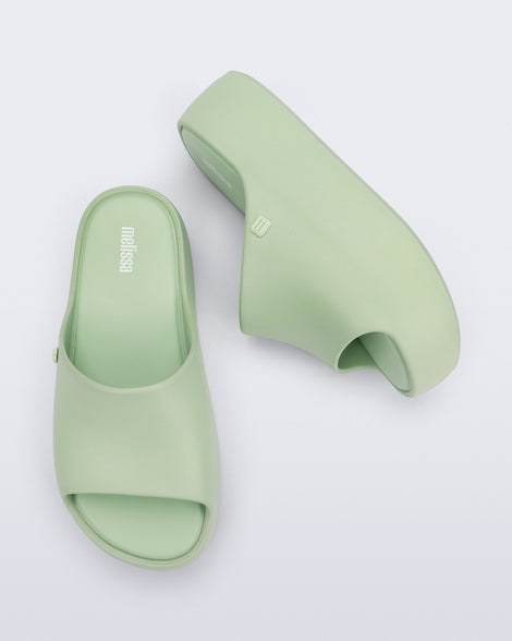 Side and top view of a pair of light green Free Platform Slide sandals