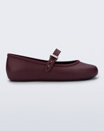 Side view of a burgundy Soft Ballerina flat with top strap and silver buckle