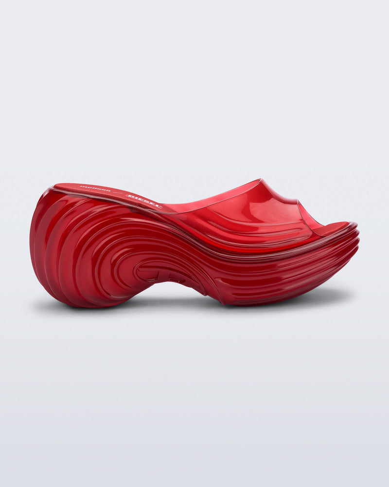 Side view of a transparent red Platforms + Diesel slides