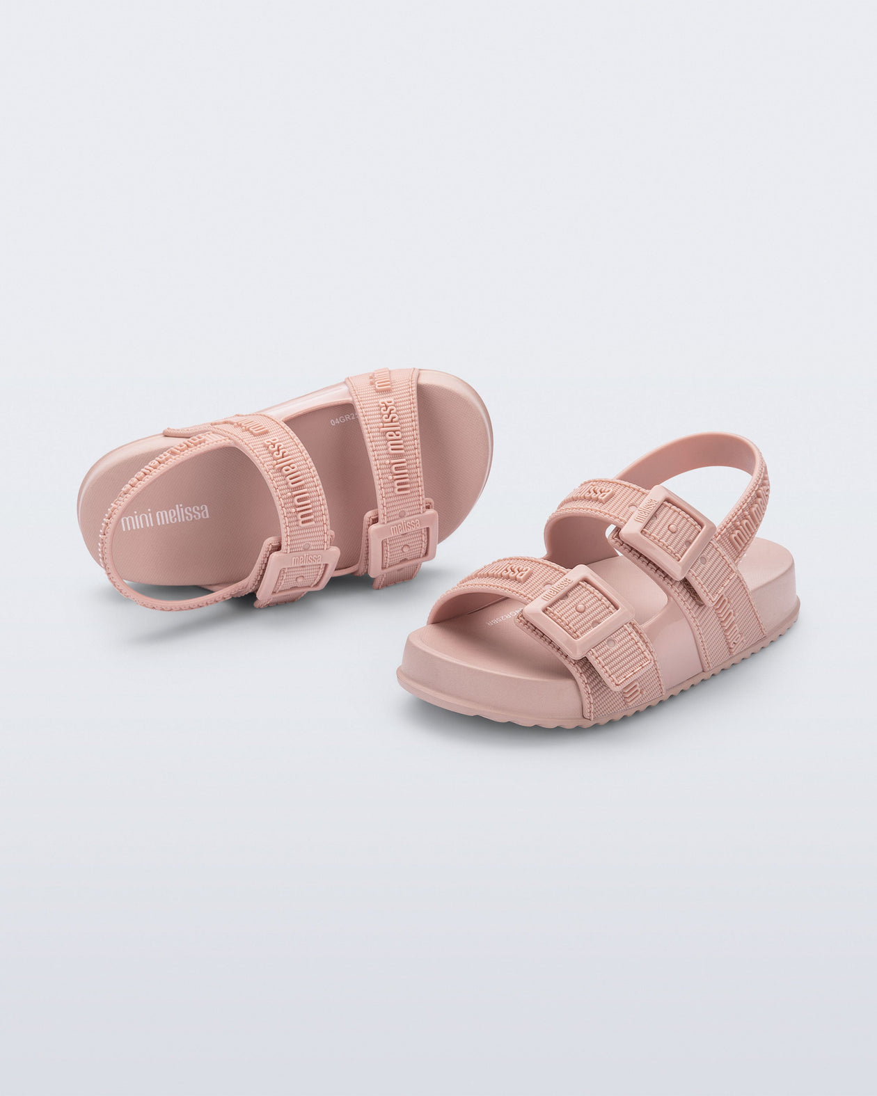 Top and angled view of a pair of pink Cozy M Lover baby sandals