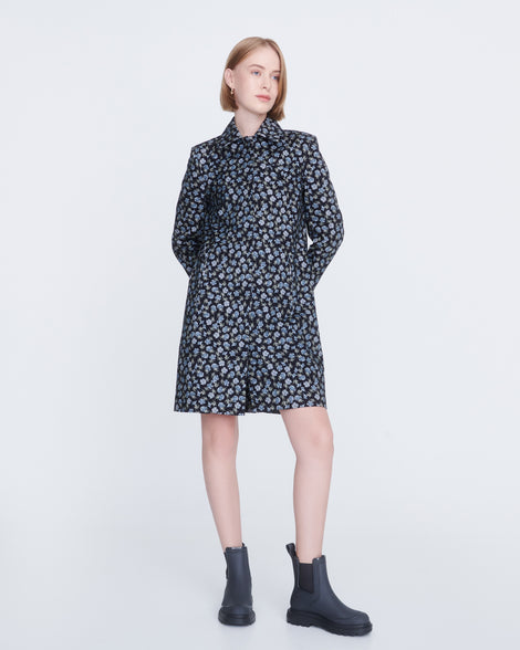Model in a multicolored short jacket wearing a pair of grey Noir boots with black sole