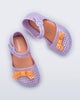 Top view of a pair of lilac Pop baby flats with orange bow