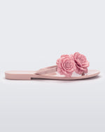 Side view of a pink Harmonic Springtime women's flip flop with 3 pink flowers.