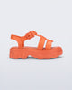 Side view of a orange Ella kids sandal with heel strap