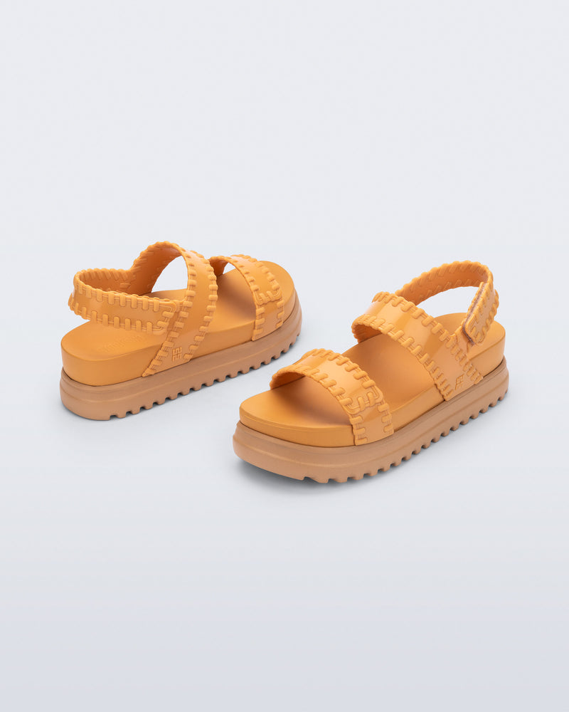 Back and angled view of a pair of orange Dune Platform Sandals with faux stitching on the straps and beige sole
