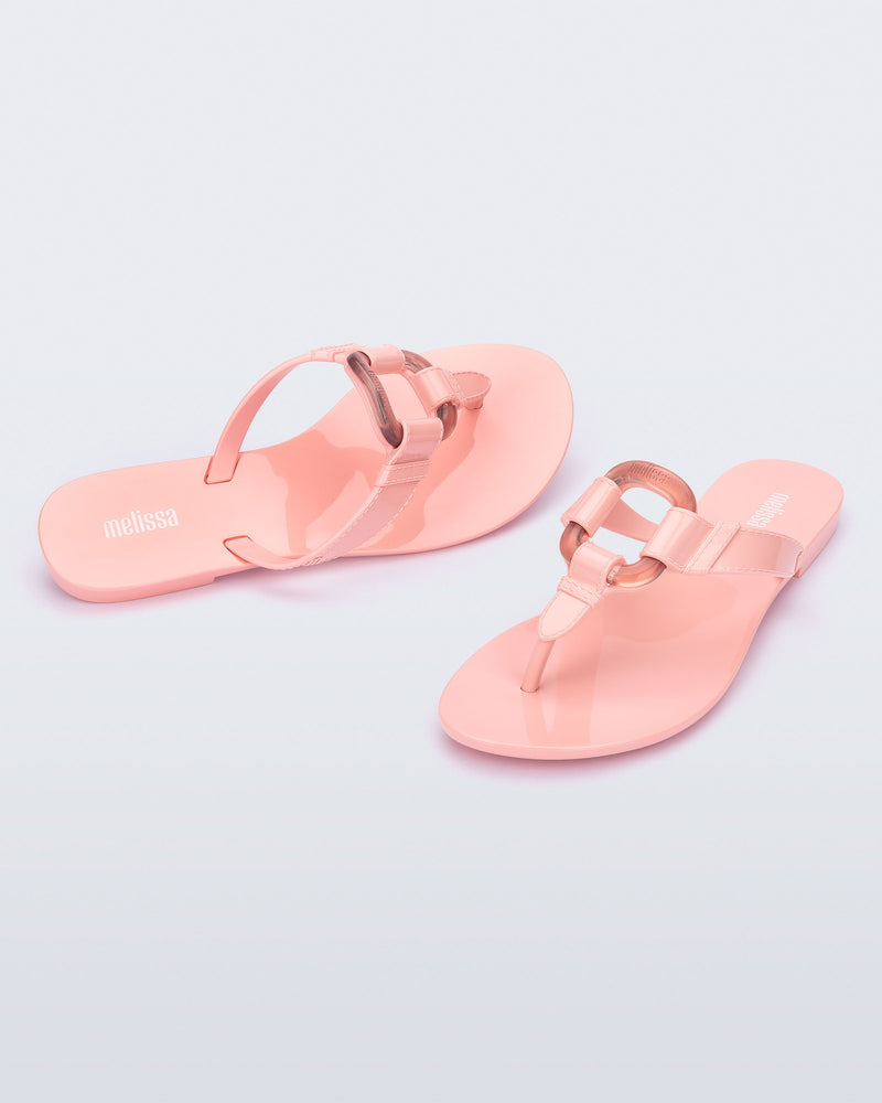 Angled view of a pair of pink Olivia adult flip flops