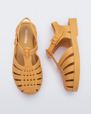 Top and side angled view of a pair of matte burgundy Possession kids fisherman sandals.