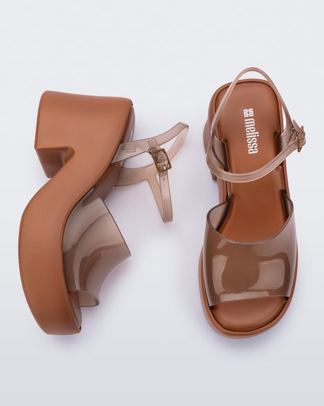 Top and side view of a pair of clear brown Lina platform heels