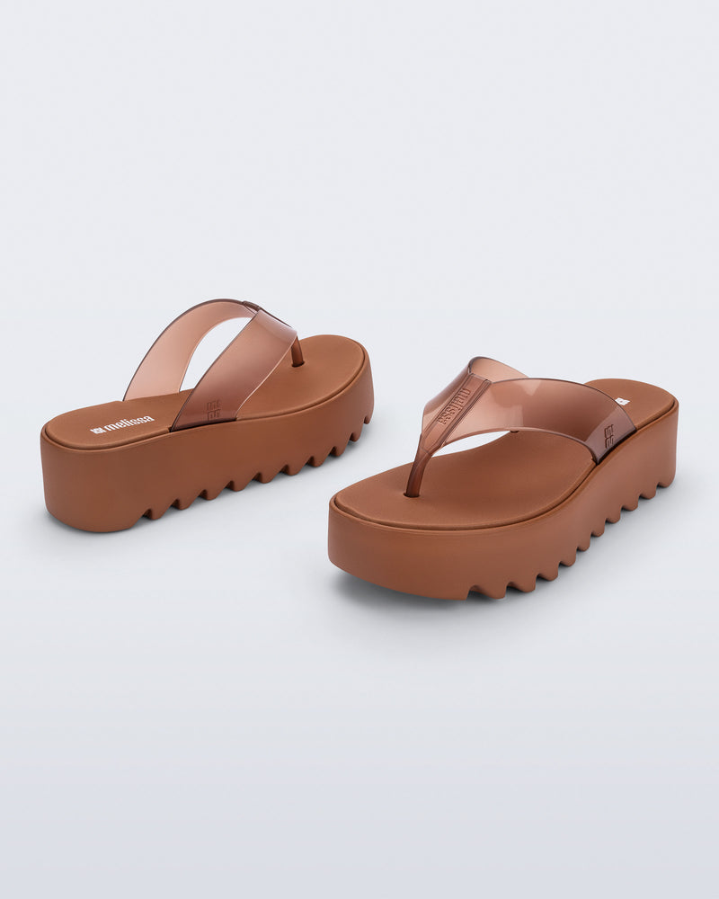 Angled and back view of a pair of brown Thong Platform flip flops