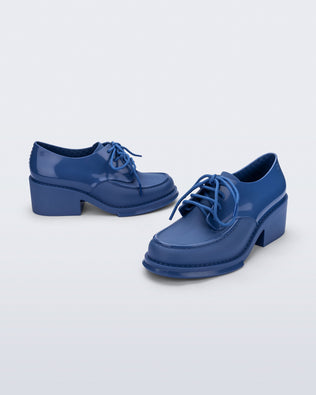 Side and angled view of a pair of blue Tailor loafers
