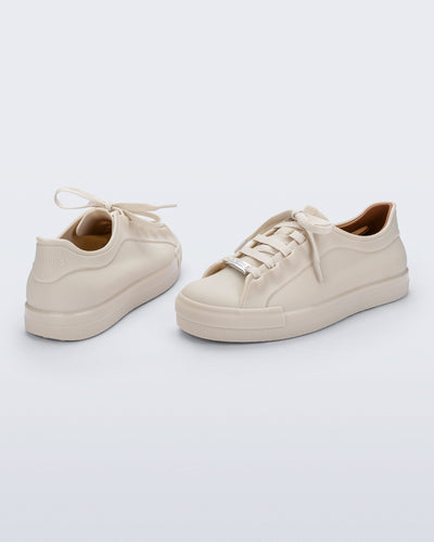 Back and angled view of a pair of beige Wow Sneakers with beige laces
